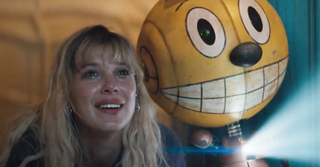 a smiling girl with a grinning yellow robot sidekick