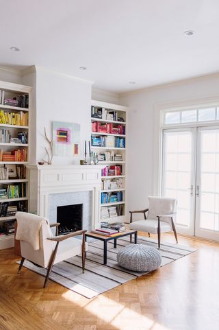 rainbow color coordinated books in white living room