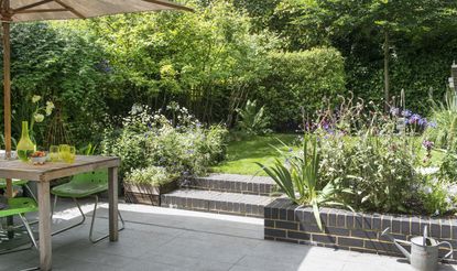 Patio with brick steps and floral patio edging