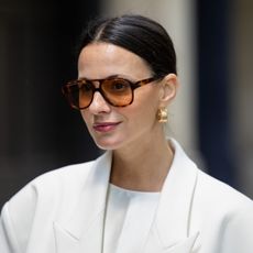 woman wearing aviator sunglasses with a light berry lipstick