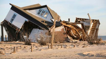 A house on the beach is destroyed after a storm.