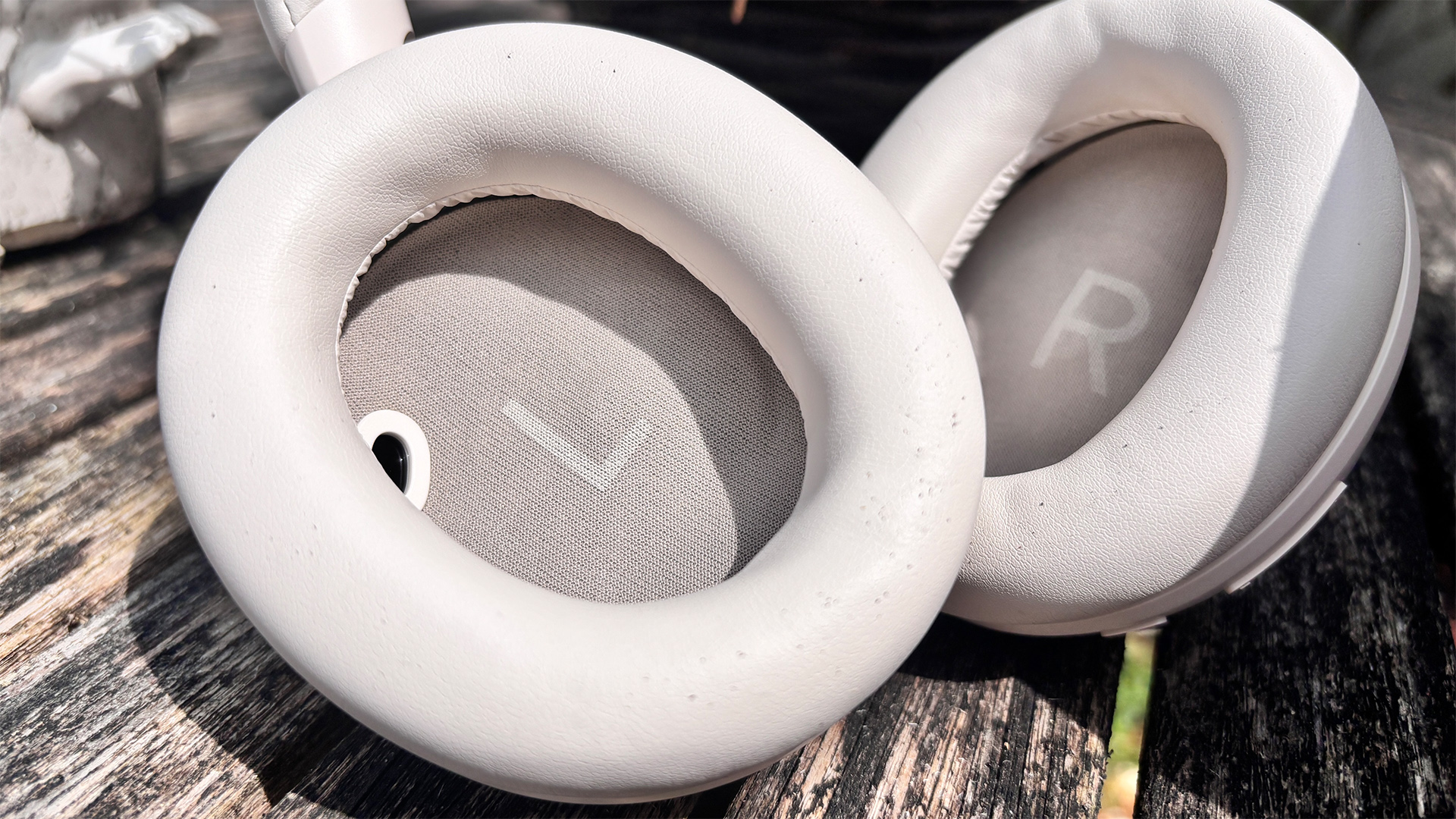 Soundcore Space 2 wireless headphones on wooden surface, inner earcups with L and R visible