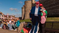 A woman stands with a cutout of President Donald Trump outside the U.K.’s Windsor Castle 