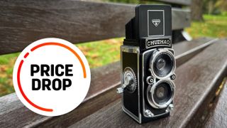 Chuzhao TLR camera on a wooden bench with the text balloon "Price Drop"