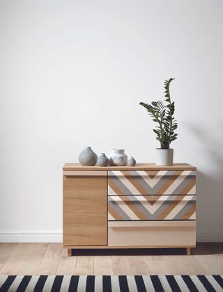 Wooden set of drawers with grey and cream painted chevron design