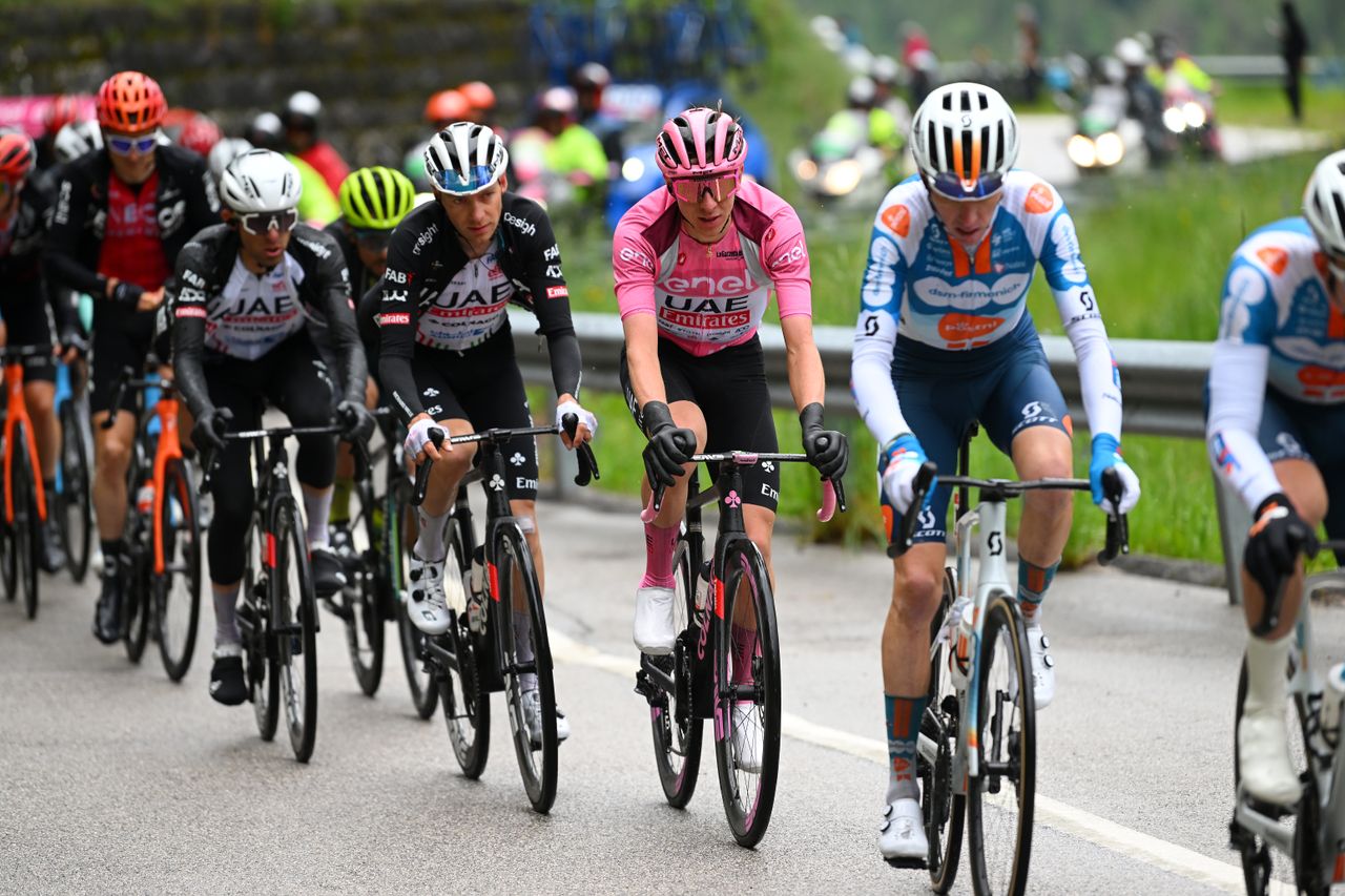 Tadej Pogacar riding with some neoprene gloves off whilst in the maglia rosa at the Giro