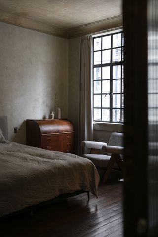 A bedroom in dark tones
