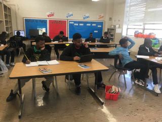 Boys working in the classroom with desktop and laptop computers