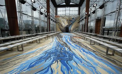 Showing the catwalk and lining the floor were hand-painted swirls based on satellite images of Machu Picchu, the Atacama Desert and the Nazca Lines