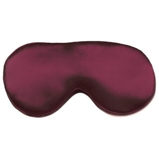 A burgandy sleep mask cut out on a white background