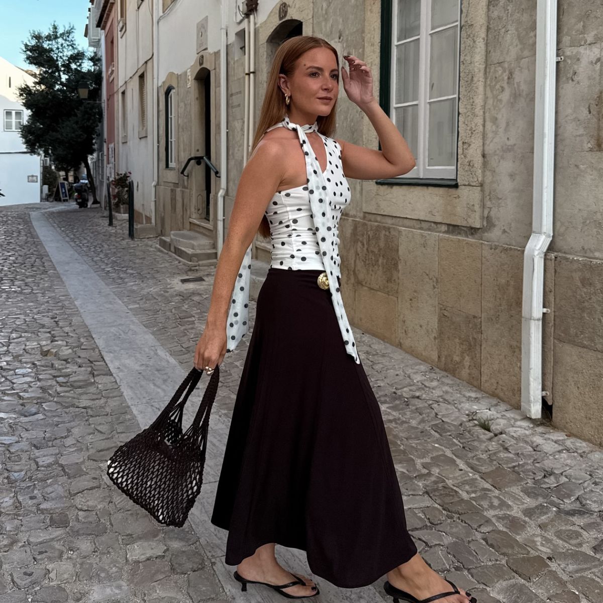 An image of @rebeccaferrazwyatt wearing a polka-dot top. 