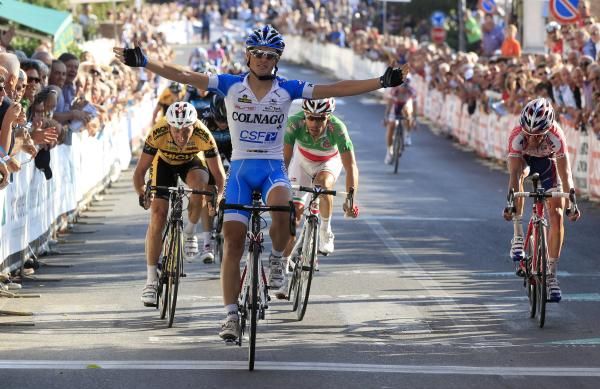Enrico Battalgin (Colnago CSF-Inox) celebrates with Davide Rebellin and Italian champion Giovanni Visconti in the background.