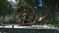 A player reclines on a deckchair while another players runs in a giant hamster wheel in Rust.