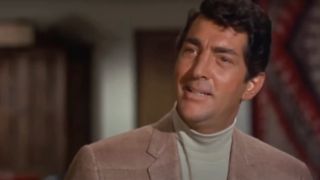 Dean Martin smiles in a light brown jacket and turtleneck in The Silencers.