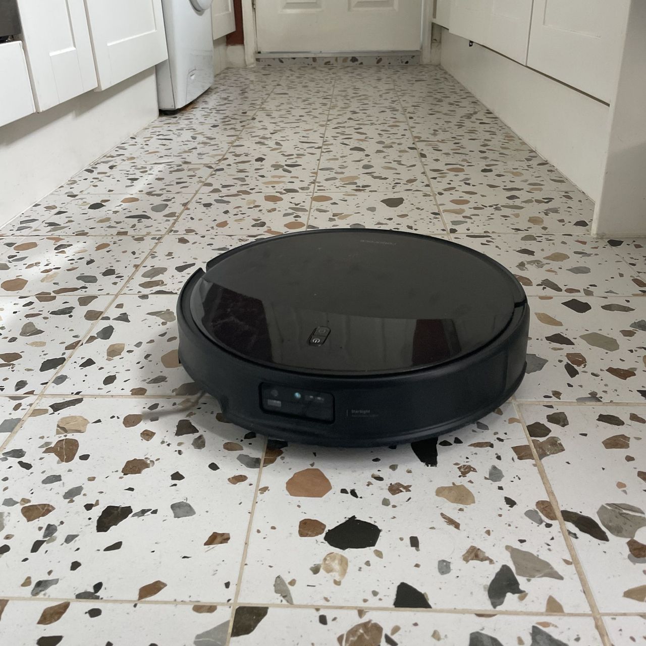 Roborock Saros 20 Robot Vacuum cleaning terrazzo tiled floor in a kitchen