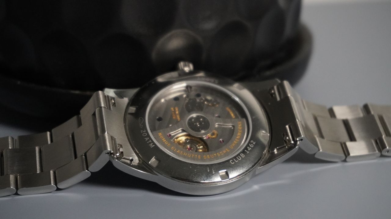 The Nomos Club Sport Neomatik on a grey and black background
