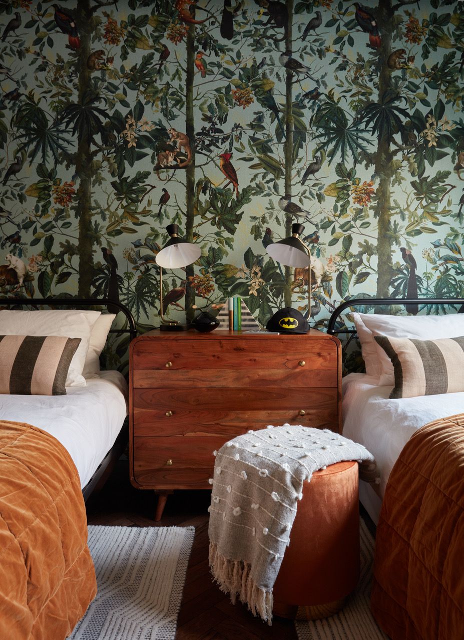 A bedroom with green wallpaper