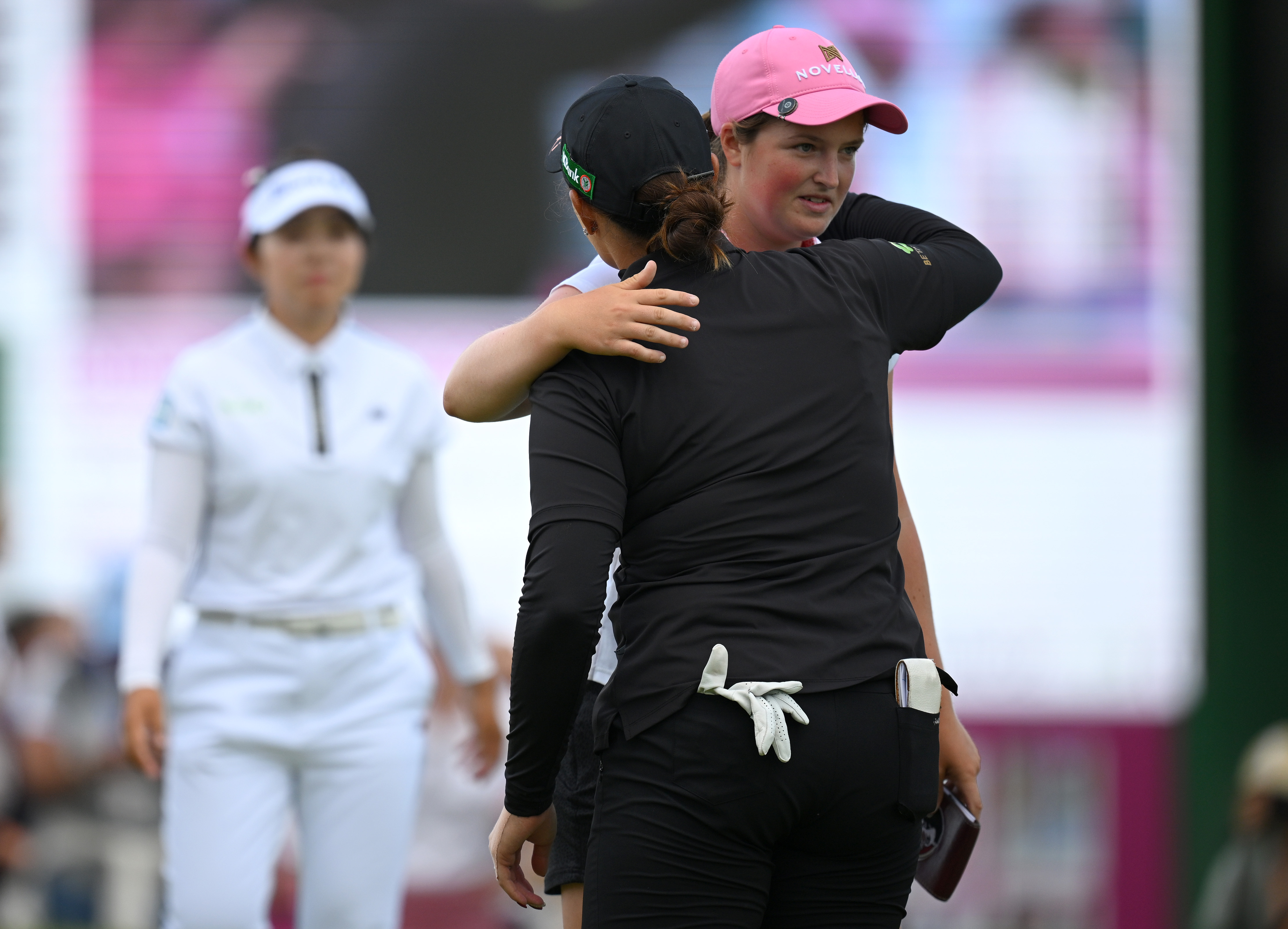 Lottie Woad hugs a player on the 18th hole