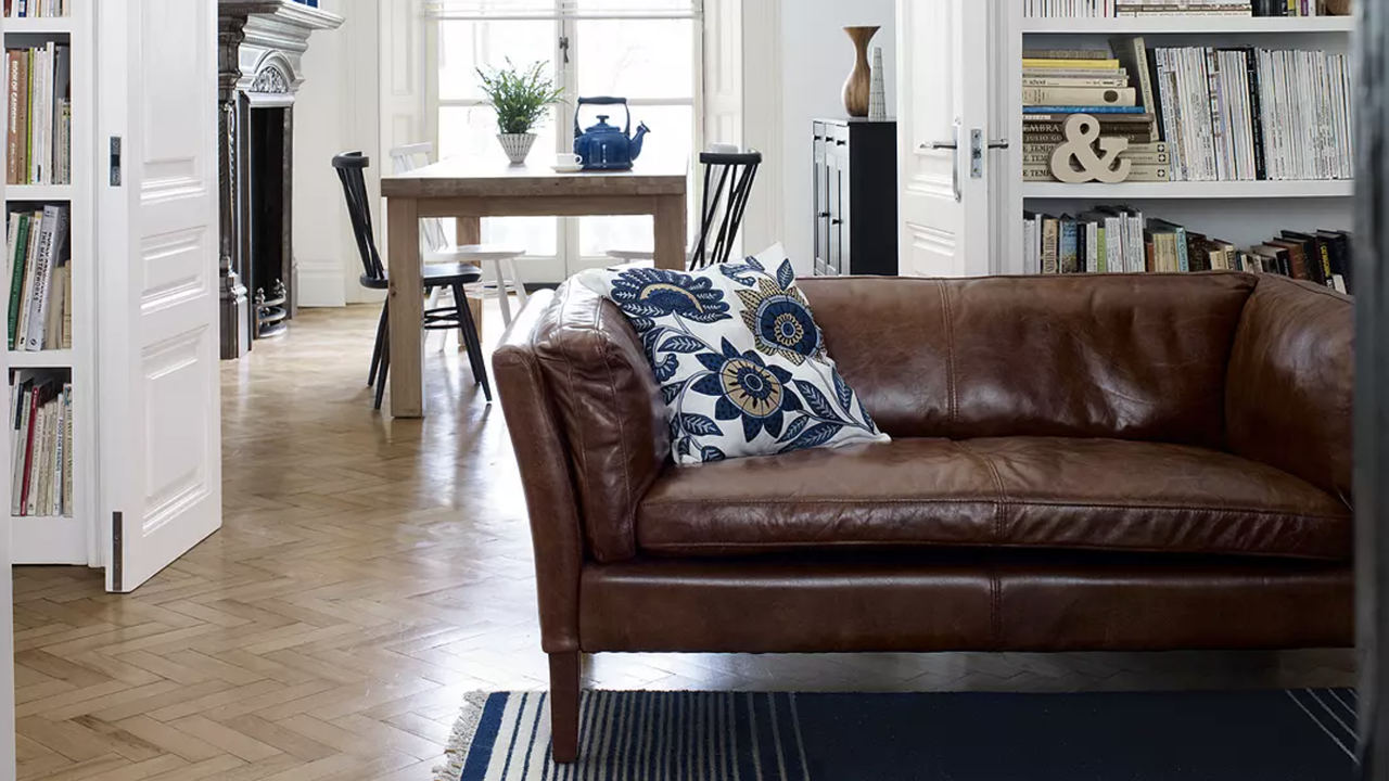 a leather sofa and dining table and looks of bookcases