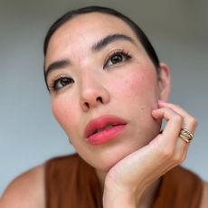 Selfie of a woman posing with her head resting in her hand.