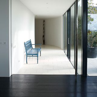 hallway with wooden flooring and wooden chair
