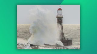 Photograph of a wave crashing into a lighthouse 