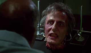 Dr. Hill grits his teeth while talking in Bride of Re-animator.
