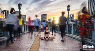 Woman Meditating Into The Crowd At Sunset by Filippo Bacci