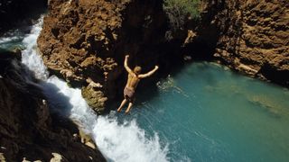 Man jumps into water in Grand Canyon