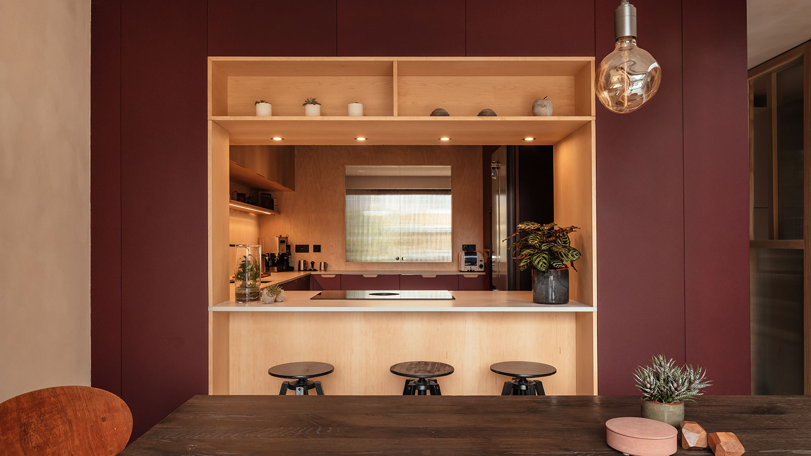 kitchen pod space with ply walls and burgundy painted walls