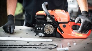 Work in the workshop, changing the chain in the chainsaw