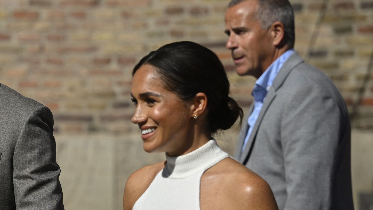 Meghan Markle&#039;s low bun and cream halter neck make subtle nod to her wedding day