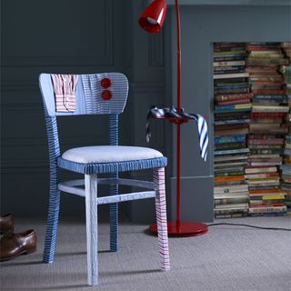 blue designed chair and red lamp