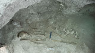 The skeleton of a 30- to 40-year-old female from the uppermost layer of the tomb. She wore a decorated Egyptian ivory disc on her chest that had been part of the shroud and dated to about 1300 B.C.