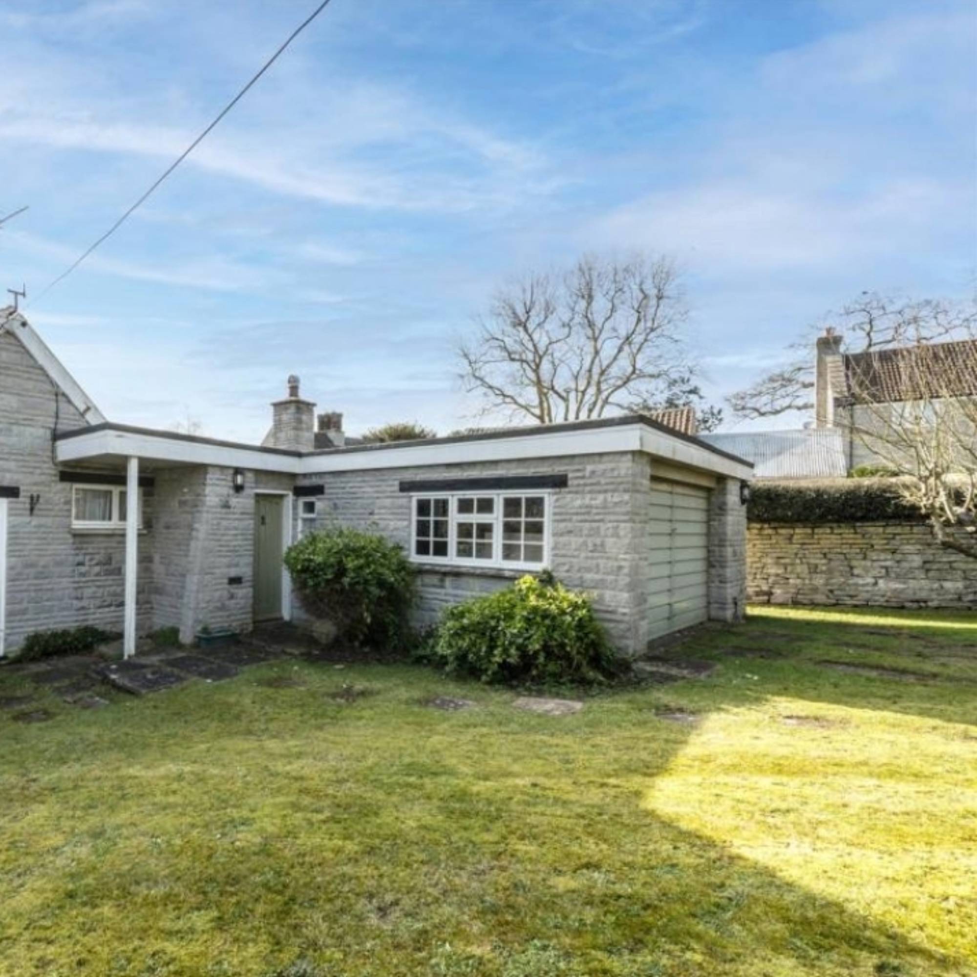 before picture of stone clad garage and lawn