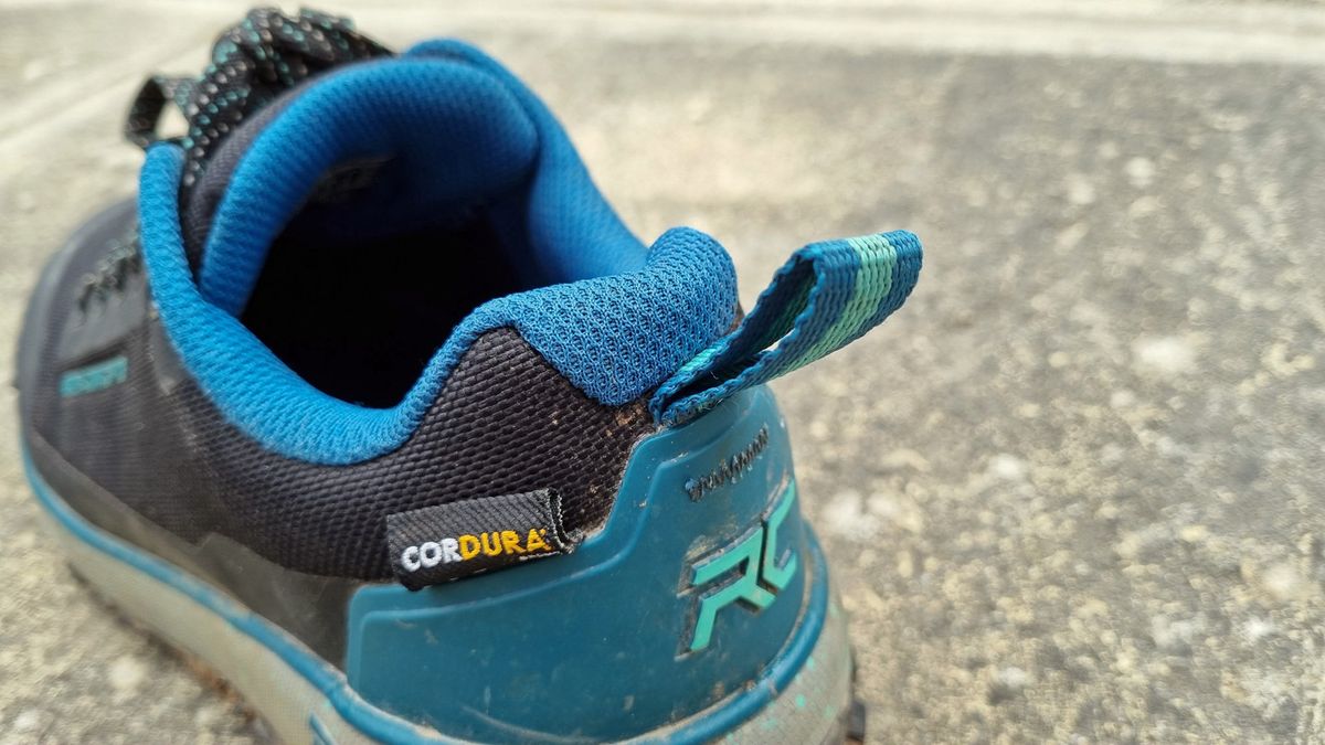 A close up rear view of some blue Ride Concepts Flume shoes, showing the heel tug loop