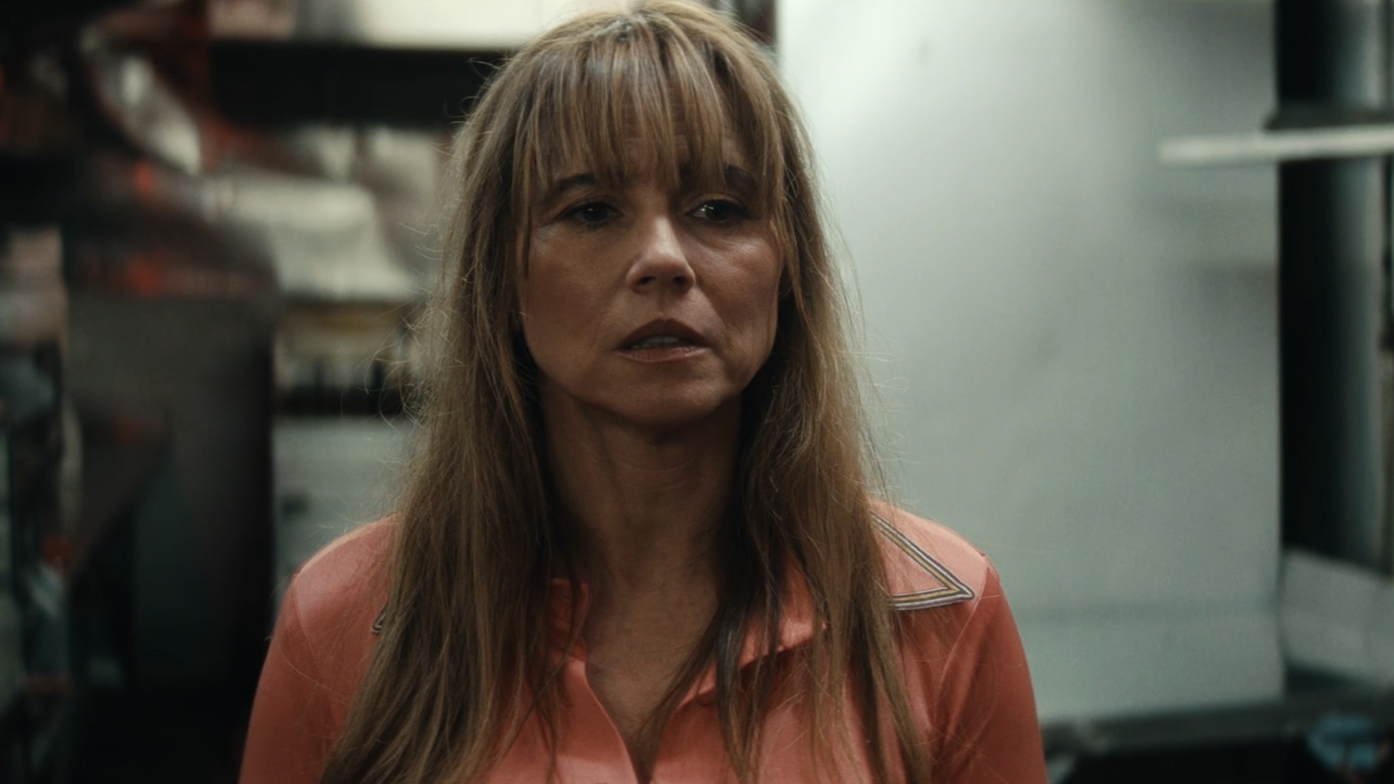 Pamela Voorhees wearing an orange dress in a restaurant kitchen in Episode 3 of Crystal Lake.