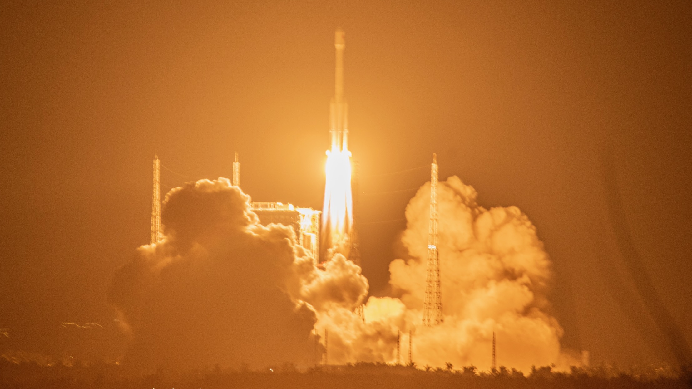 long-distance photo of a rocket launching at night