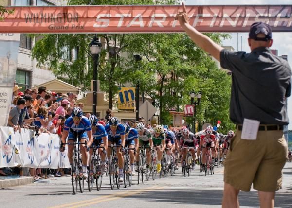 Announcer Richard Fries informs the riders one lap to go.