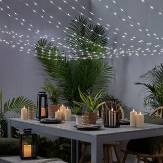 grey patio table with canopy lights above