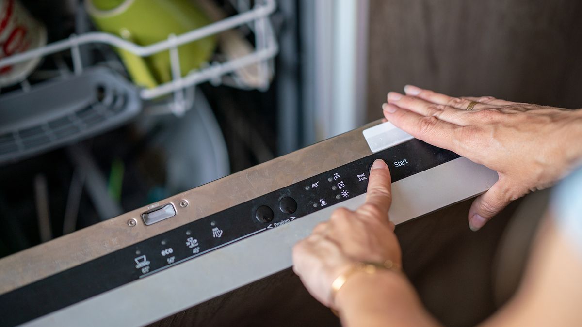 Person switching a dishwasher onto a cycle length 