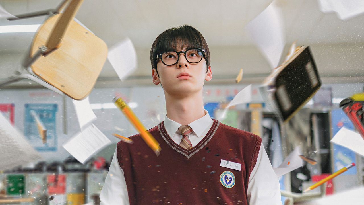 Korean high school student Yoon Ga-min (Hwang Min-hyun) sits in a classroom, with papers and pencils flying around him, in the K-drama &#039;Study Group.&#039;