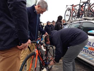 Officials check the KTM bikes of the Delko Marseille-Provence KTM team.