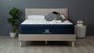 Sleep Editor lying on her side on the Brooklyn Bedding Aurora Luxe w pillow top