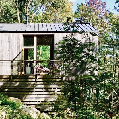 Wooden cabin in front of a snow-capped mountain