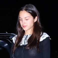 Olivia Rodrigo wears a black Doen mini dress with Dr Martens Mary Janes