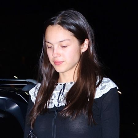 Olivia Rodrigo wears a black Doen mini dress with Dr Martens Mary Janes