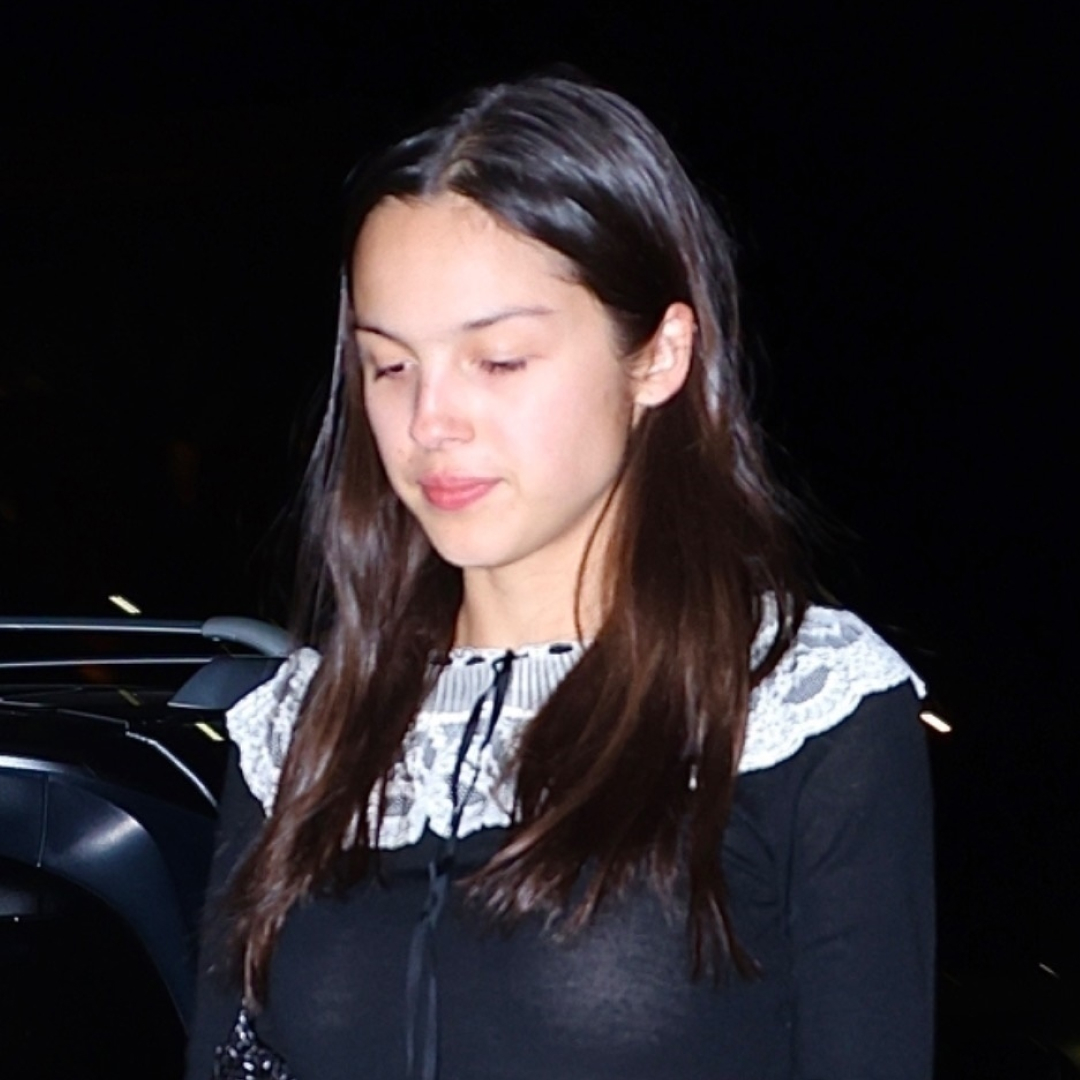 Olivia Rodrigo wears a black Doen mini dress with Dr Martens Mary Janes