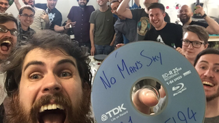 Sean Murray holding up a disc labeled "No Man's Sky" on the day it went gold in 2016.