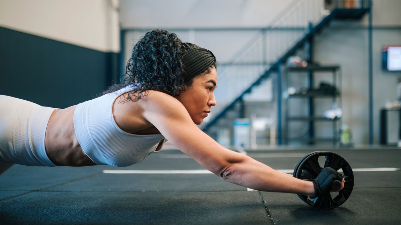 Woman using an ab roller